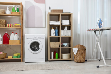 Laundry room interior with washing machine and furniture