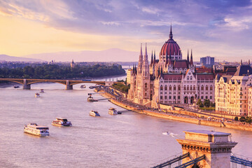 City summer landscape at sunset - view of the Hungarian Parliament Building and Danube river in the...