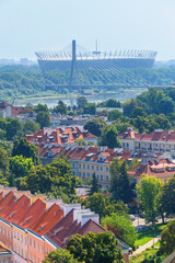 Cityscape - top view of neighbourhood of Powisle near the Vistula river and the Stadion Narodowy in the background, in center of Warsaw, Poland - obrazy, fototapety, plakaty