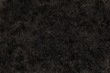 Abstract black plastered textured grunge background in the form of a rough covered stucco wall,...