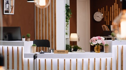 Five star hotel lobby with empty front desk at reception, classy expensive holiday resort for...