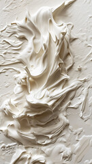 Creamy white textured paint strokes on a surface.