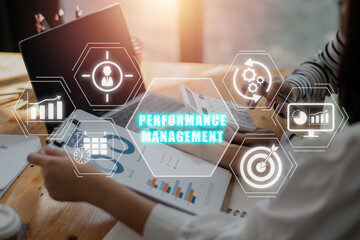 Performance management concept, Business team analyzing income charts and graphs on office desk with performance management icon on virtual screen. - obrazy, fototapety, plakaty