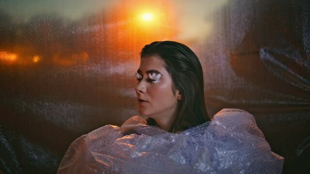 Artistic model bubblewrap posing outdoors closeup. Fantasy style woman face 