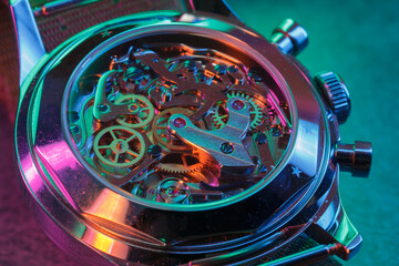 Close up detail of a macro clockwork inside a shiny iron wristwatch with sapphire rear glass bottom. - 774498338