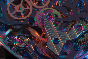 Close up detail of a macro clockwork inside a shiny iron wristwatch with sapphire rear glass bottom. - 774498344