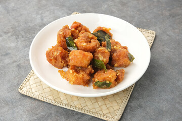 Salted egg fried shrimp or udang telur asin with curry leaves
