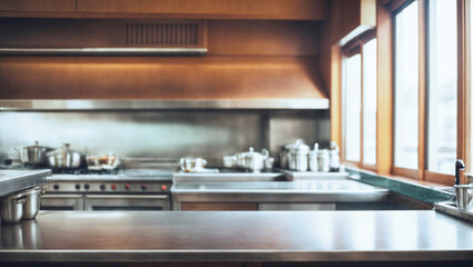 Aluminum countertop of an empty restaurant kitchen with unfocused background illuminated by natural light through a window. Hotel kitchen.