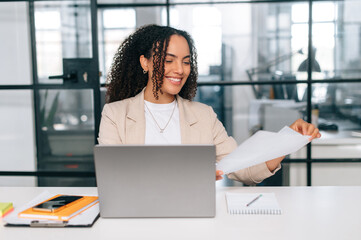 Working with documents. Positive brazilian or hispanic business woman, company employee, financial...