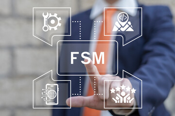 Business man using virtual touch screen presses abbreviation: FSM. FSM Field Service Management...