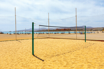 Volleyball net on the sandy beach. Playa del Castillo in Fuerteventura, Canary Island