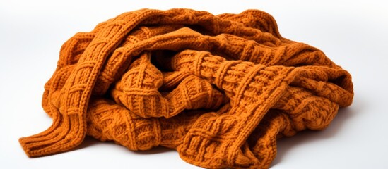 Colorful assortment of cozy orange knitted scarves neatly stacked on a clean white surface