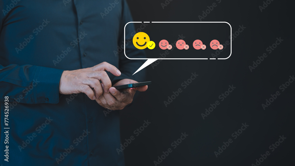 Poster A male hand uses a mobile phone displaying a happy smile face icon to express satisfaction with the service, indicating a very impressed opinion rating.