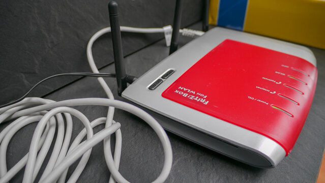 Close-up of Red FritzBox Fon WLAN Wireless Router with Ethernet Cables