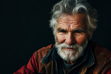 Portrait of an old man with gray beard and mustache on black background