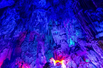Papier Peint photo Guilin beautiful illuminated multicolored stalactites from karst Reed Flute cave