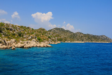 View of the rocky shore from the sea. Mediterranean Sea in Turkey. Popular tourist places. Background