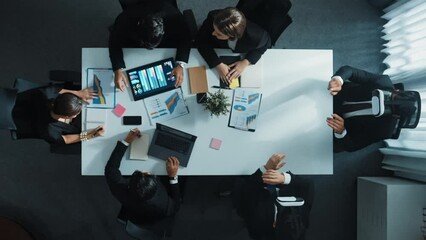Top view of smart project manager use vr headset while business team discuss about marketing plan by using stock market graph from tablet and send data to virtual world. Technology. Directorate.