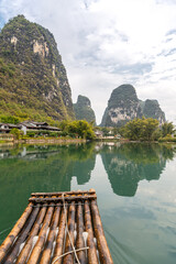 Naklejka premium Beautiful Li river bamboo side Karst mountain landscape in Yangshuo, China