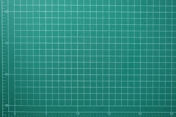 green cutting mat board background with line and scale measure guide pattern for object art design, tool equipment of diy craft work