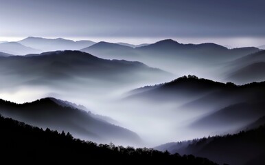 Obraz premium Majestic Mountain Range Shrouded in Fog and Mist
