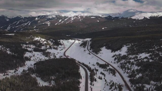Vail Pass Colorado i70 highway cars trucks sky chutes Copper Mountain ski resort trail runs ten mile range Ikon snowy winter spring snowy peaks evening clouds sunset forward reveal motion
