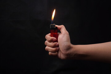 hand holding lighter isolated dark background