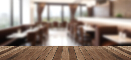 Empty wood tabletop or counter with display product. Blur image of restaurant interior background.