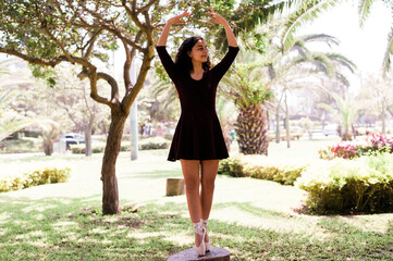 Ballet dancer practicing outdoors in a park