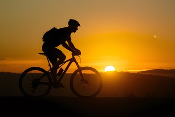 Capture Sunset silhouette of man cycling on mountain bike, outdoor activity photo