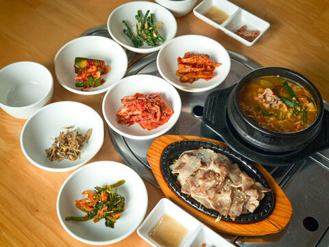 Korean grilled sliced meat and soy bean paste soup with side dishes.