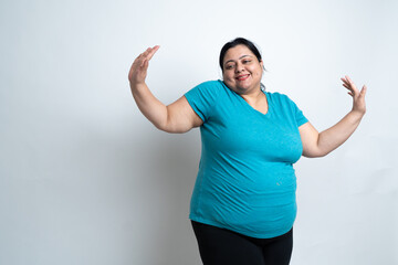 Overweight fat indian woman dancing against white background. joyful Plus size female. Healthcare, Mental health, weight loss,, obesity, stress free, chilling, copy Space