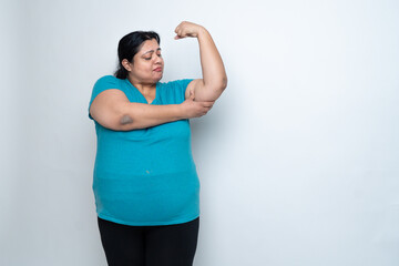 Overweight fat indian woman showing her muscles or strength. isolated over white background. Plus...