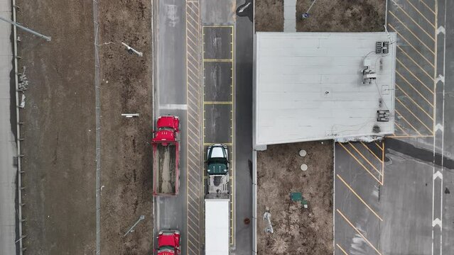 Aerial shot pointing straight down on a Weigh Station where a truck rolls in for inspection