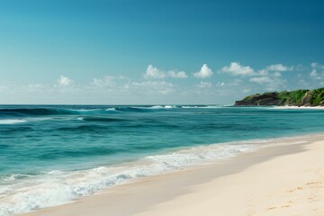 Fototapeta na wymiar Ocean waves on sandy beach with clear blue sky, tranquil