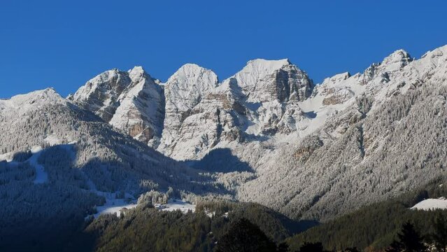 Early November first snow on Europe Australian Swiss Alps peaks fall autumn Stubai Village chalet Tirol Tyrol Austria frosted morning sunshine Innsbruck mountains landscape static shot