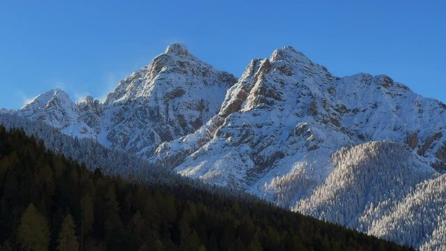 Early November morning first snow on Europe Australian Swiss Alps peaks fall autumn Stubai Village chalet Tirol Tyrol Austria frosted sunshine Innsbruck mountains landscape static shot