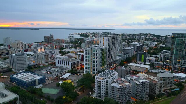 Aerial Drone of Darwin City CBD Australia NT Orbit around Buildings with Sunset Sunrise Glow in Sky