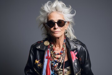 Portrait of stylish senior woman with short white hair and sunglasses.