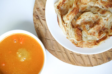 Roti Parata or Roti canai with curry sauce, a popular Malaysian breakfast