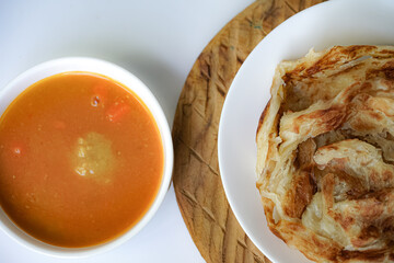 Roti Parata or Roti canai with curry sauce, a popular Malaysian breakfast