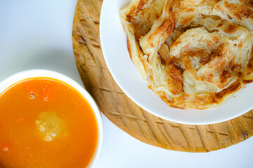 Roti Parata or Roti canai with curry sauce, a popular Malaysian breakfast