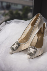 Elegant bridal heels with intricate lace detailing, poised gracefully.