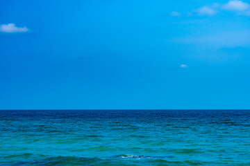 Ocean sea background and the clear sky For summer vacation ideas Nature of summer sea water with sunlight The sea sparkles against the blue sky.	
