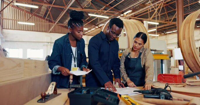 People, teamwork and wood workshop for production building for small business manufacturing, furniture or timber. Man, women and design paperwork in warehouse for carpentry, contractor or remodeling