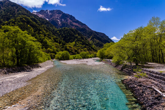 Clear, cold river running through a forested valley. River Azusa, Kamikochi, Japan