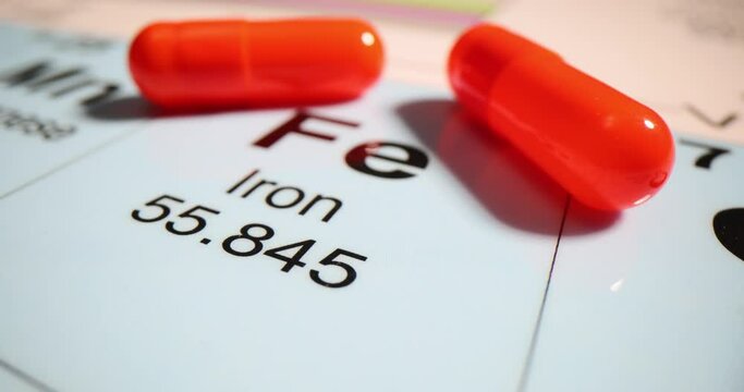 Chemical element Iron Fe with tablets. closeup