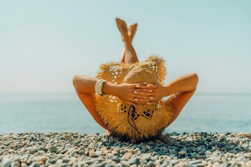 Beach Relaxation woman lies on a pebble beach, legs raised, and arms spread out. The concept of...