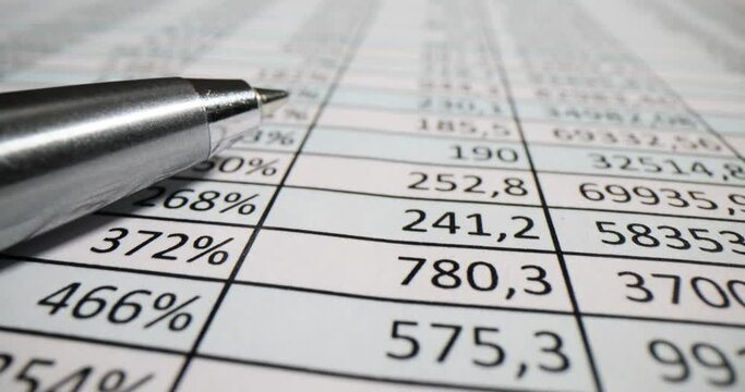 Public company accounting report and pen on the table