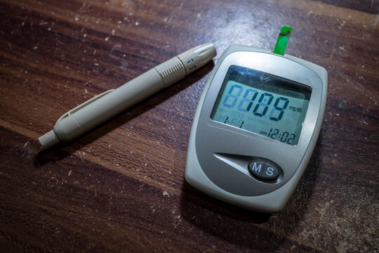 A glucometer and a lancet pen, blood glucose test, measuring glucose level blood test